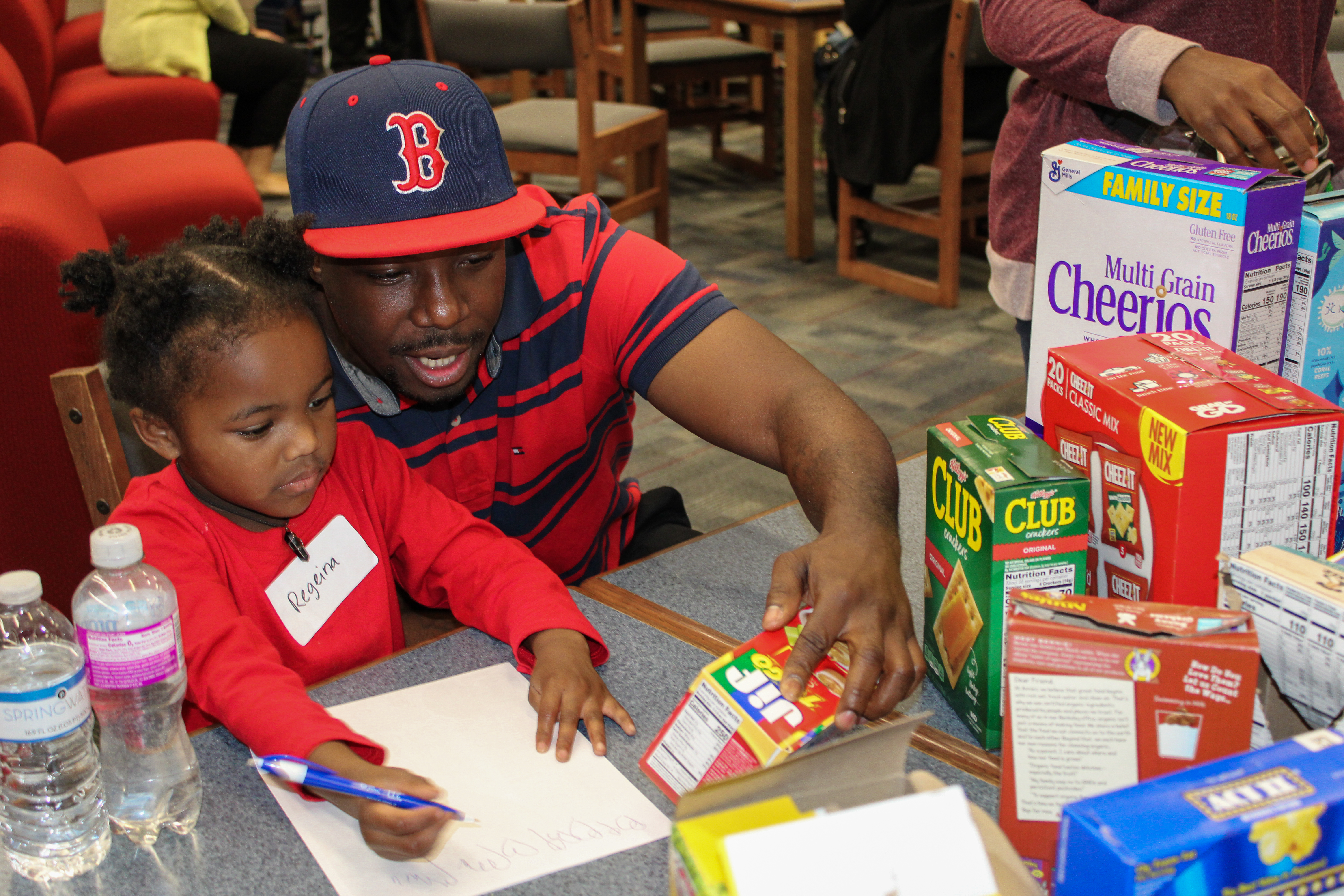 Father and daughter reading grocery products together